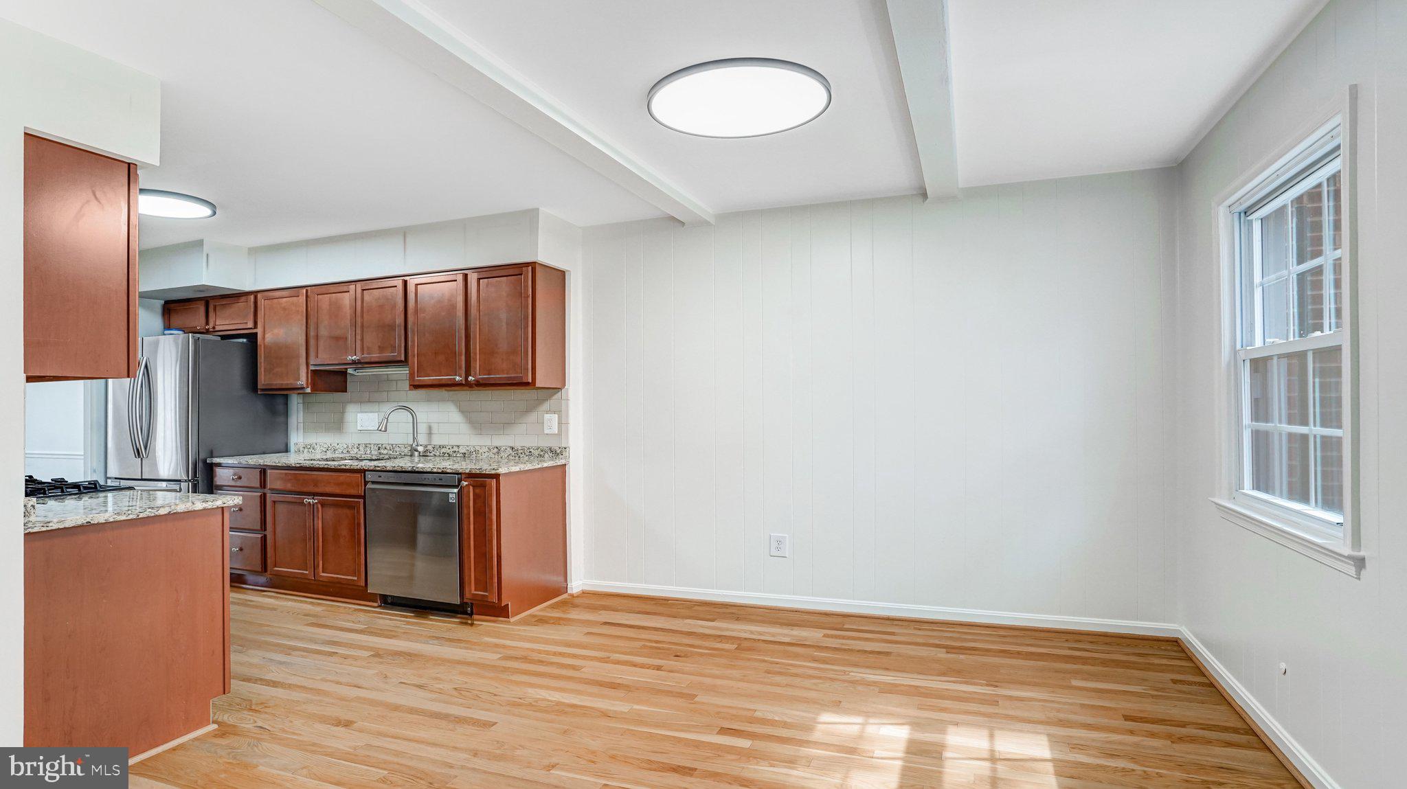 9752 Cardinal Road Fairfax, VA 22030 - Photo 4 of 37 a kitchen with stainless steel appliances granite countertop a stove a sink and a refrigerator
