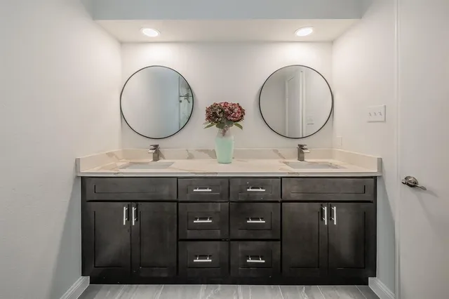 a bathroom with a double vanity sink and a mirror
