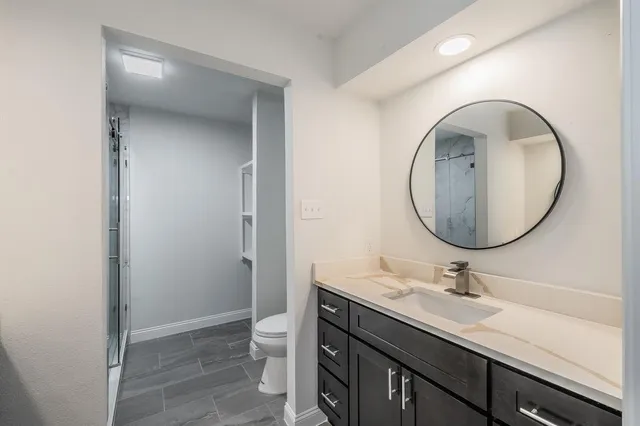 a bathroom with a sink a mirror and a toilet