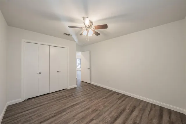 a view of an empty room and wooden floor