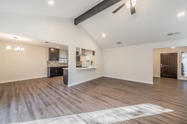 a view of kitchen and hall with wooden floor