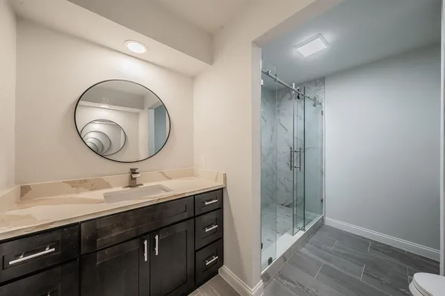 a bathroom with a double vanity sink and a mirror