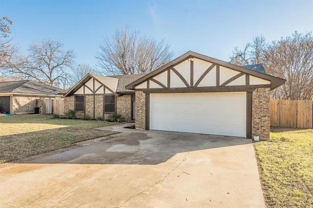 a view of a house with a yard and garage