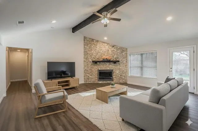 a living room with furniture flat screen tv and a fireplace