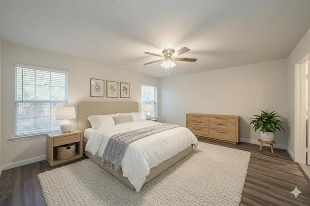 a bedroom with a large bed lamp and a chandelier