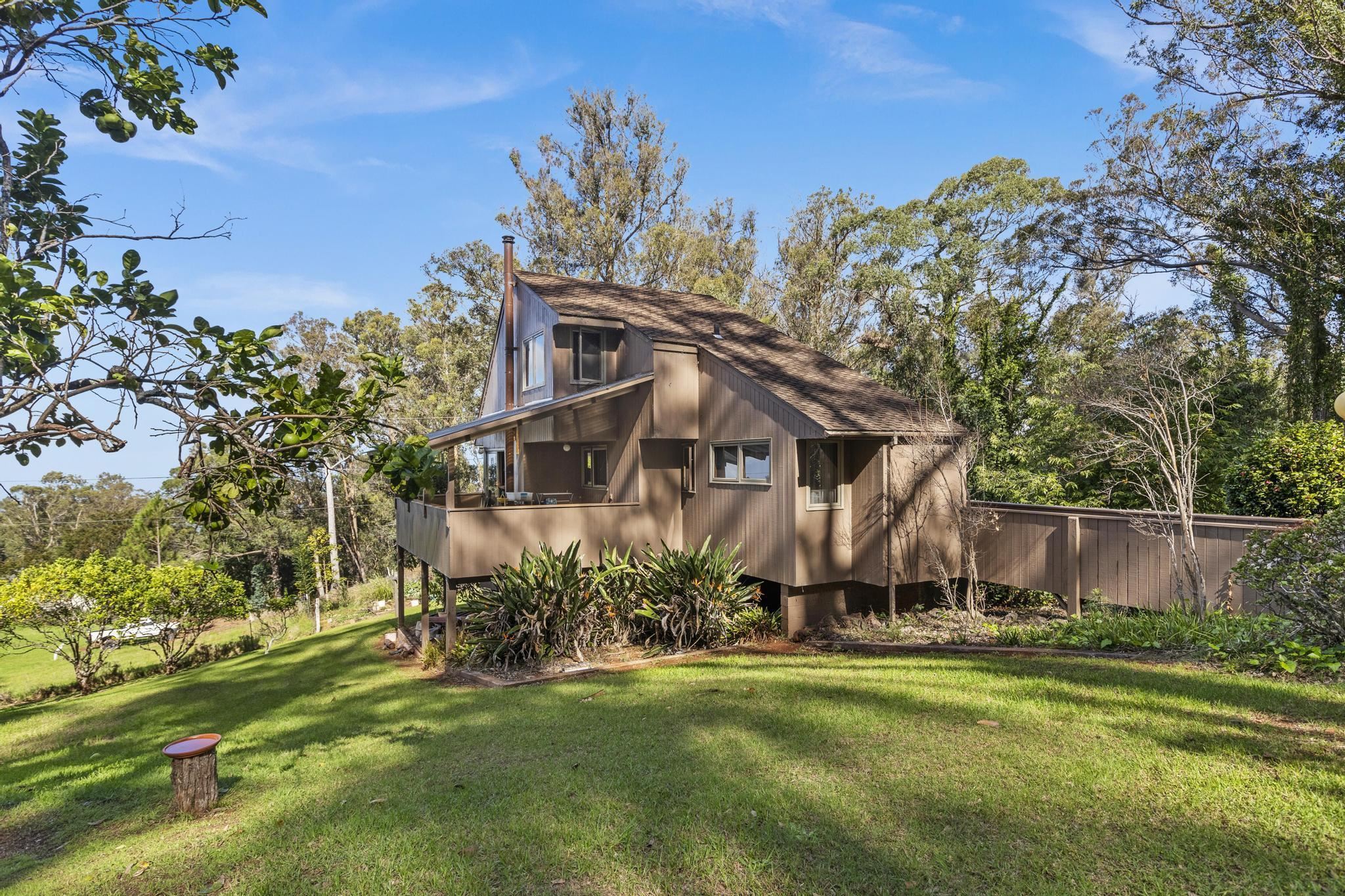 2450 Piiholo Road Makawao, HI 96768 - Photo 22 of 39 a view of a big house with a big yard and large trees