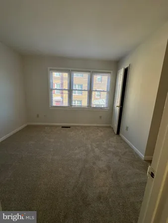 an empty room with a empty space and windows