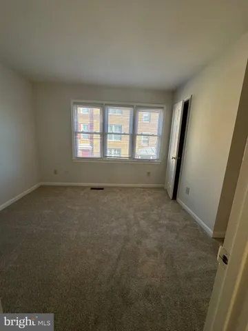 an empty room with a empty space and windows