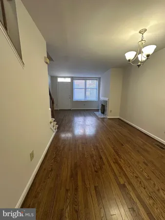 a view of a room with wooden floor and a window