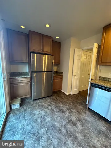 a kitchen with a refrigerator and a stove