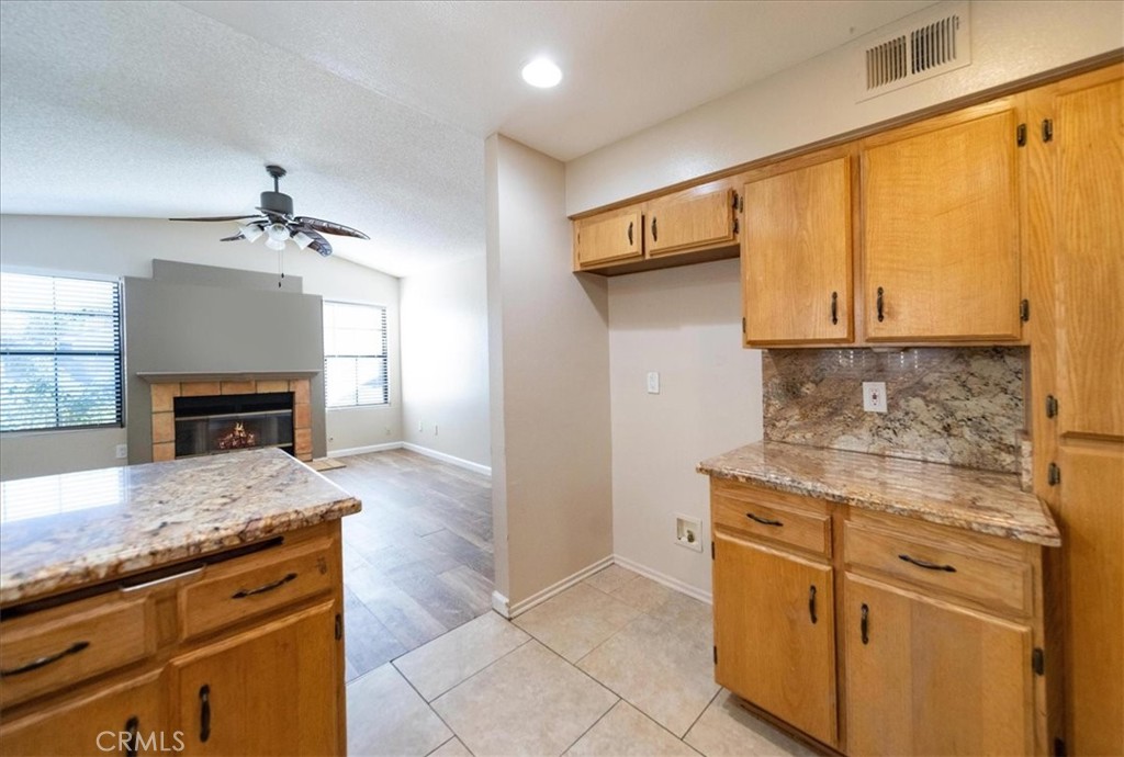 39739 Old Carriage Road Murrieta, CA 92563 - Photo 11 of 31 a kitchen with stainless steel appliances granite countertop a stove a sink and a microwave