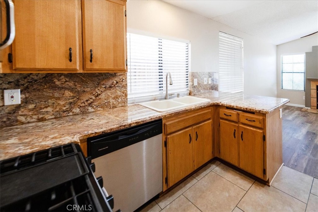 39739 Old Carriage Road Murrieta, CA 92563 - Photo 13 of 31 a kitchen with stainless steel appliances granite countertop a sink stove and cabinets