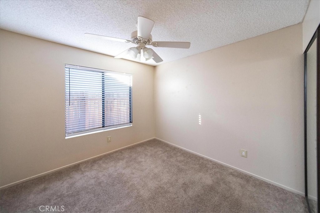 39739 Old Carriage Road Murrieta, CA 92563 - Photo 18 of 31 an empty room with windows and fan