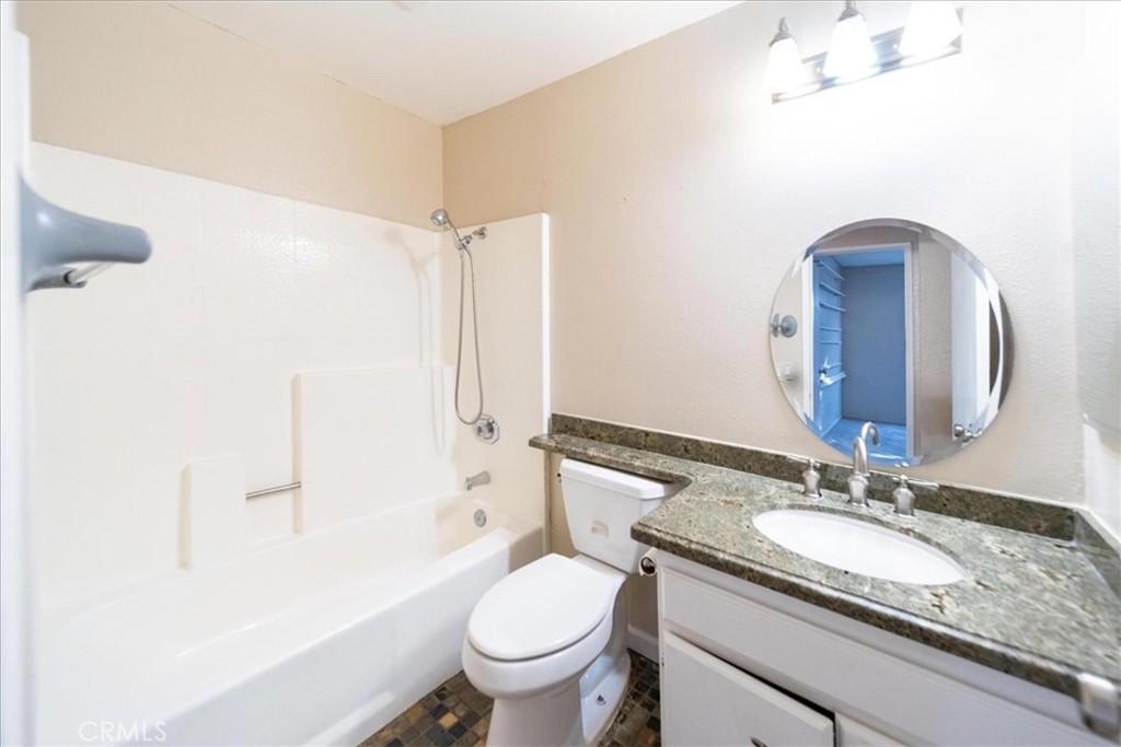 39739 Old Carriage Road Murrieta, CA 92563 - Photo 20 of 31 a bathroom with a granite countertop sink toilet and shower