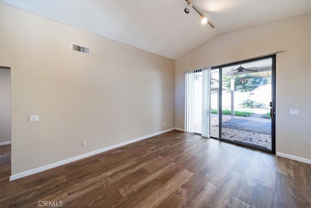 39739 Old Carriage Road Murrieta, CA 92563 - Photo 6 of 31 a view of an empty room with wooden floor and a window