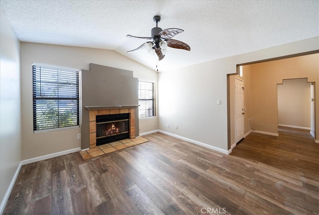 39739 Old Carriage Road Murrieta, CA 92563 - Photo 10 of 31 a view of empty room with a fireplace and wooden floor