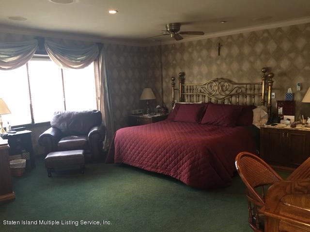 93 Romer Road Staten Island, NY 10304 - Photo 10 of 15 93 Romer Bedroom with red spread