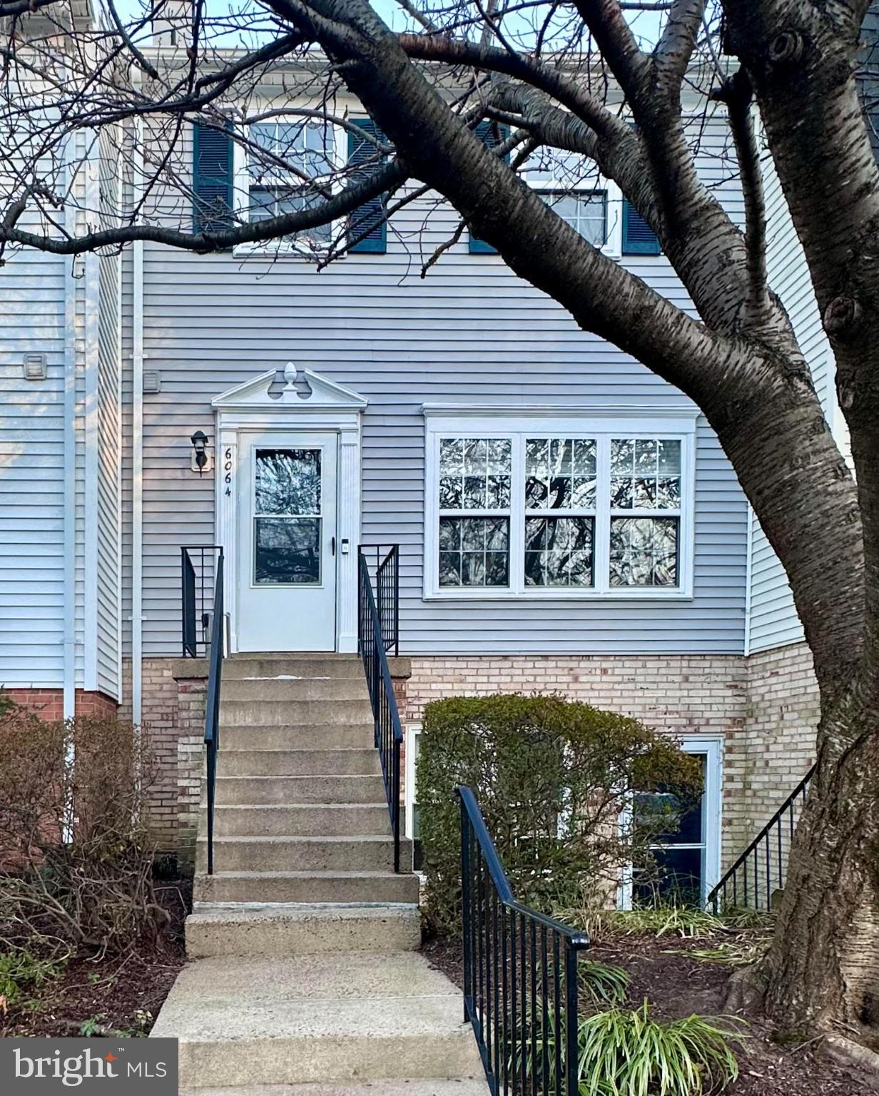 a front view of a house with stairs