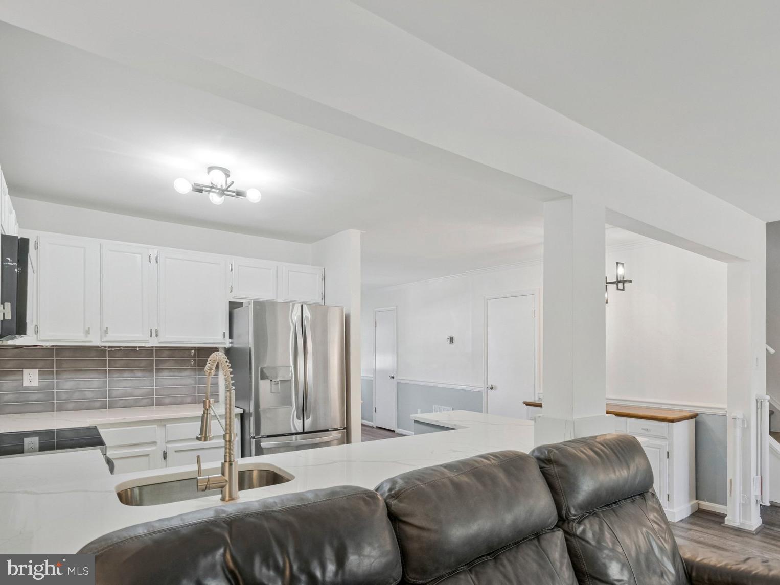 6064 Old Landing Way Burke, VA 22015 - Photo 13 of 38 a living room with a couch and a stove top oven