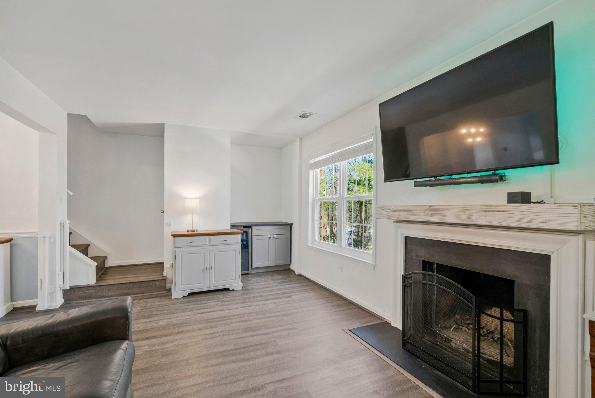 6064 Old Landing Way Burke, VA 22015 - Photo 14 of 38 a living room with furniture a flat screen tv and a fireplace