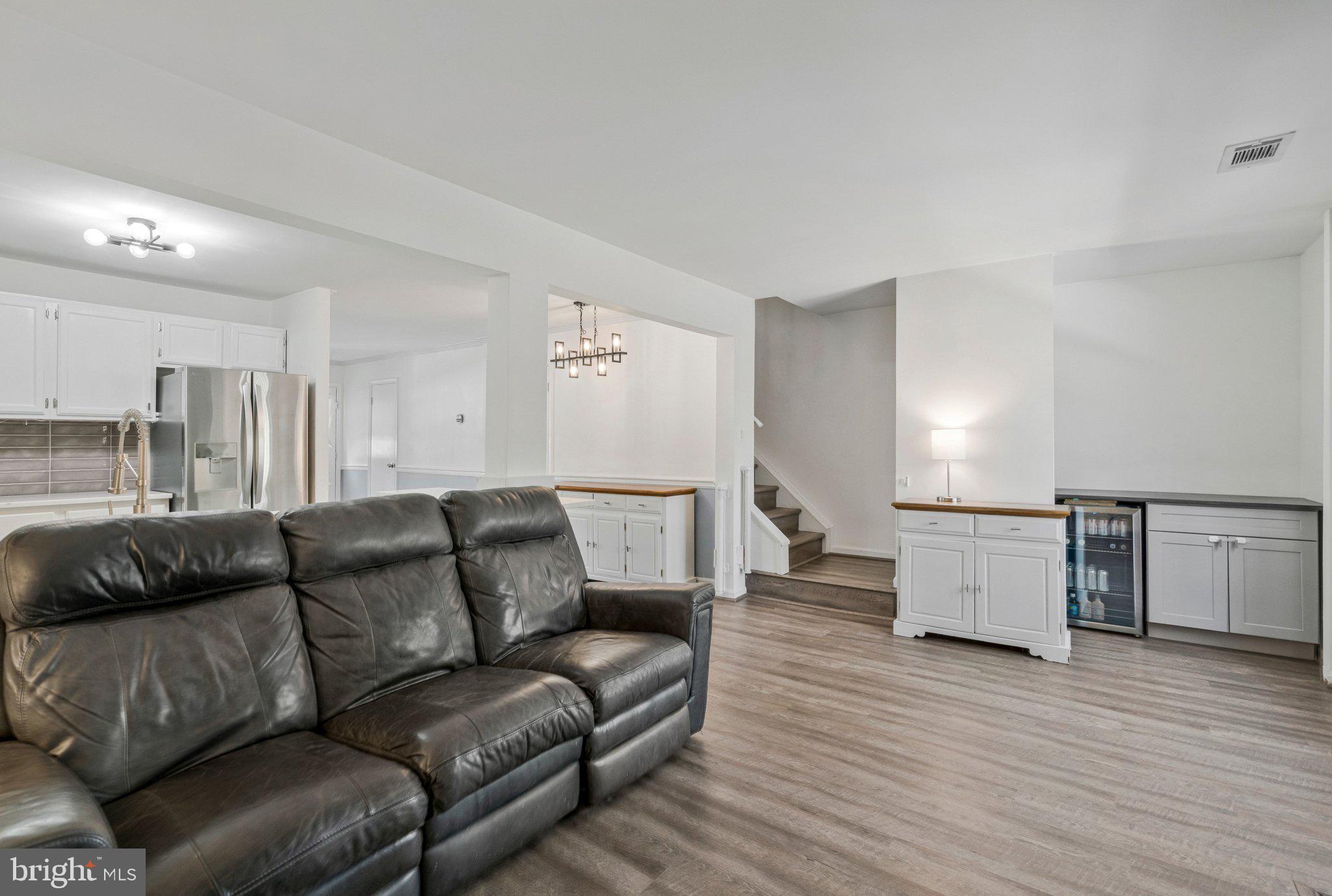 6064 Old Landing Way Burke, VA 22015 - Photo 15 of 38 a living room with furniture and a wooden floor