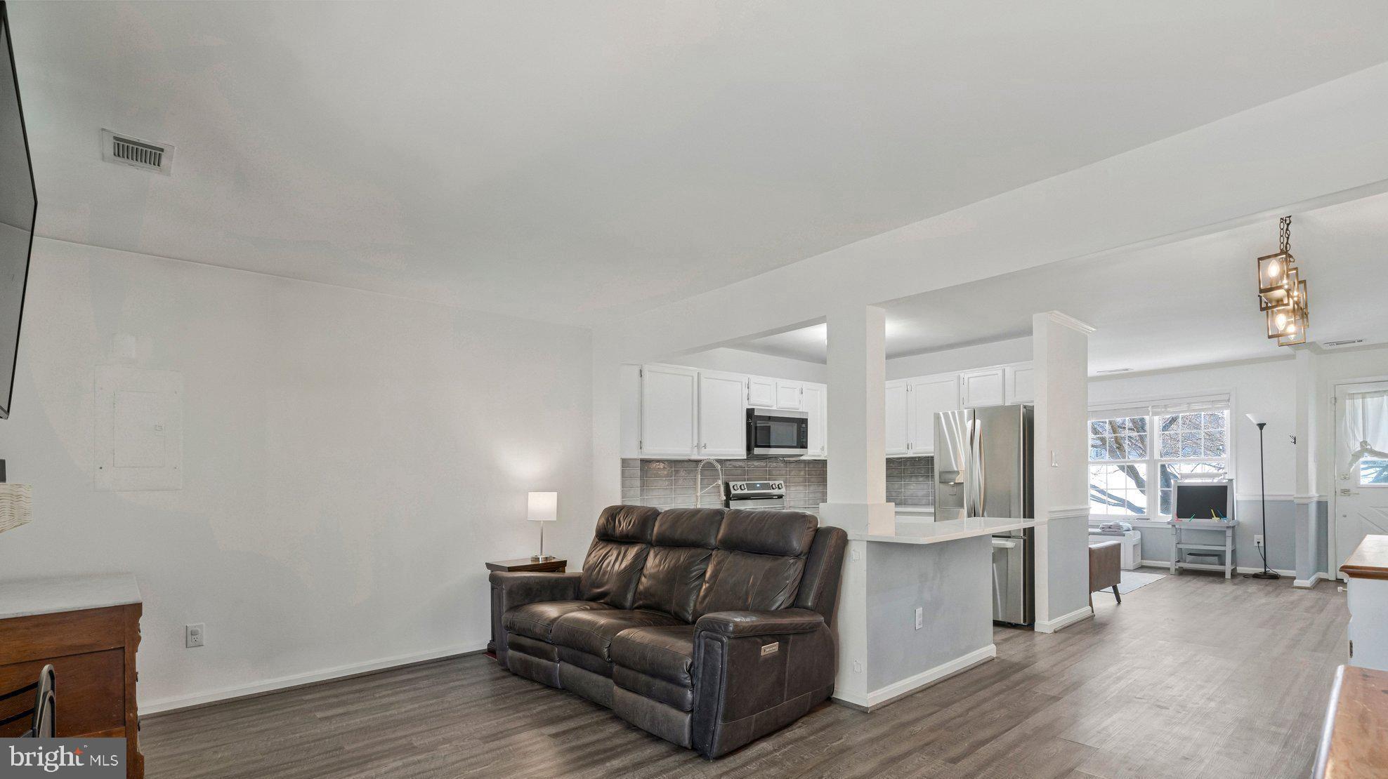 6064 Old Landing Way Burke, VA 22015 - Photo 16 of 38 a living room with furniture and a wooden floor