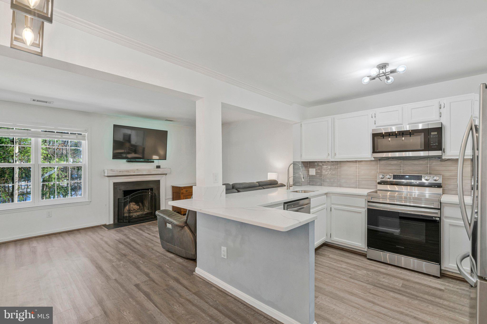 6064 Old Landing Way Burke, VA 22015 - Photo 10 of 38 a kitchen with a stove a sink and a microwave