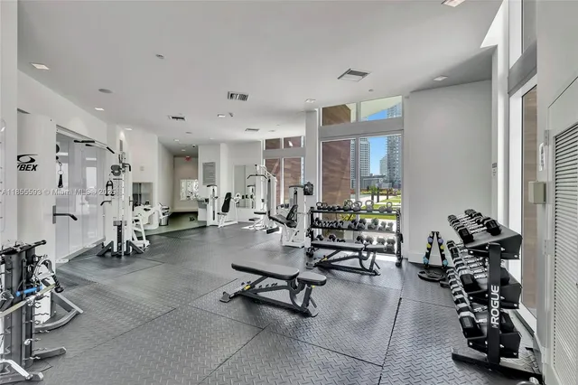 a room with gym equipment and a large window
