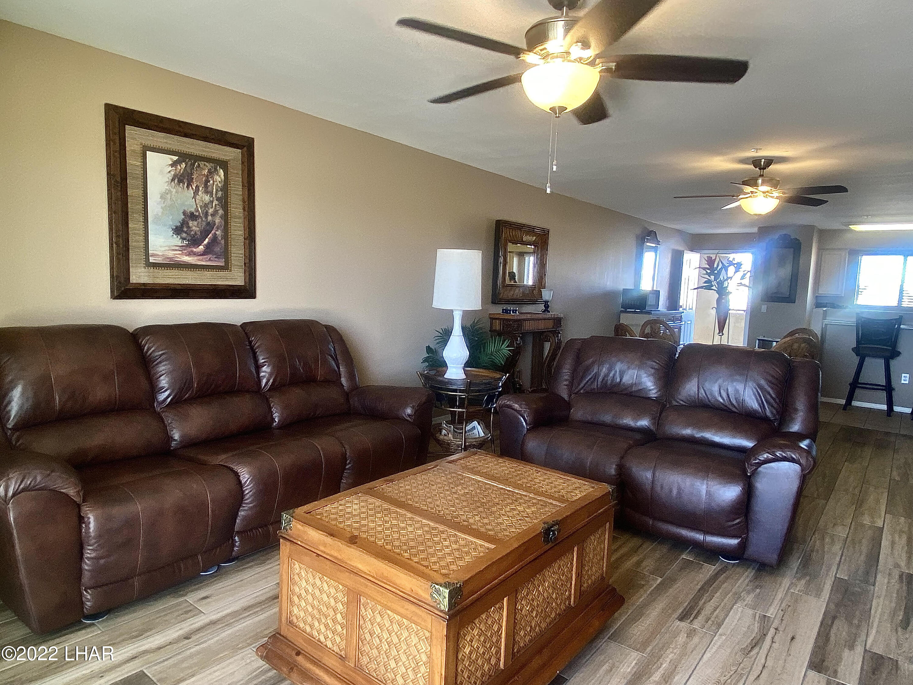 94 London Bridge Road, Unit 507 Lake Havasu City, AZ 86403 - Photo 8 of 13 a living room with furniture a ceiling fan and a rug