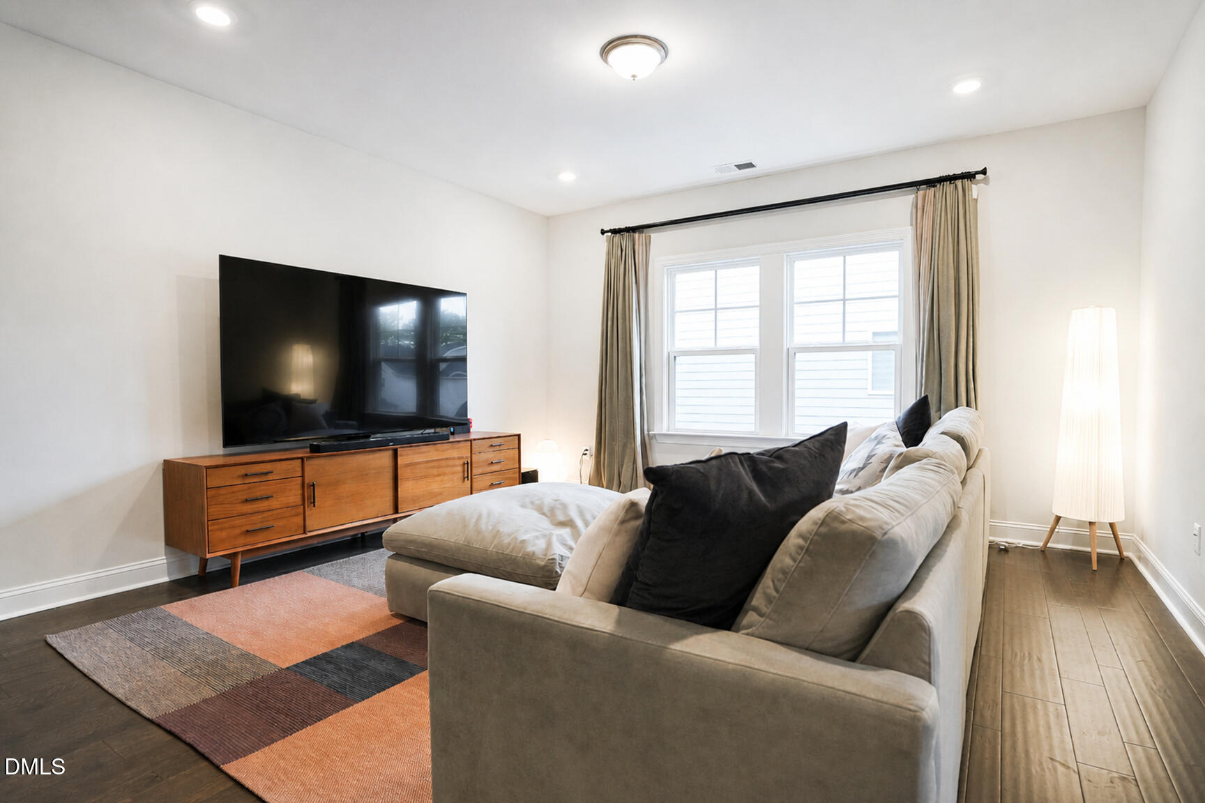 2966 Rise And Shine Road Apex, NC 27502 - Photo 28 of 61 a living room with furniture and a flat screen tv