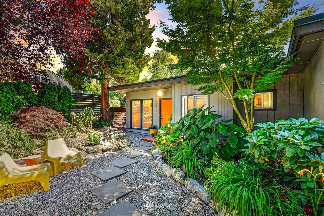 a view of a backyard with sitting area and garden