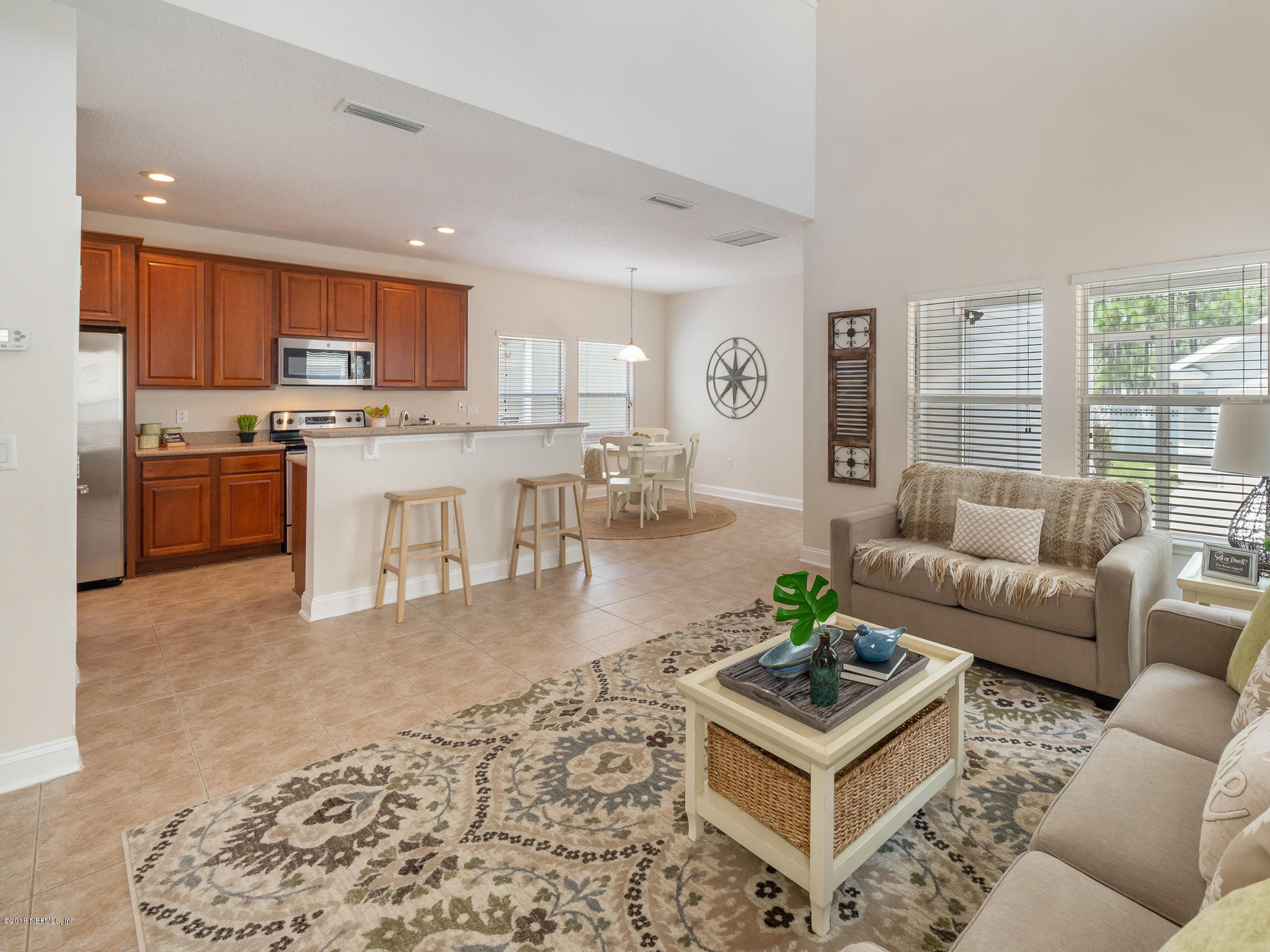 3716 Chasing Falls Road Orange Park, FL 32065 - Photo 11 of 31 a living room with stainless steel appliances furniture and a kitchen view