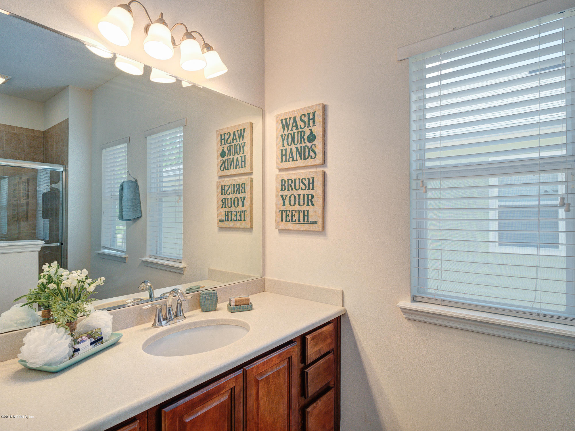 3716 Chasing Falls Road Orange Park, FL 32065 - Photo 20 of 31 a bathroom with a granite countertop sink and a mirror