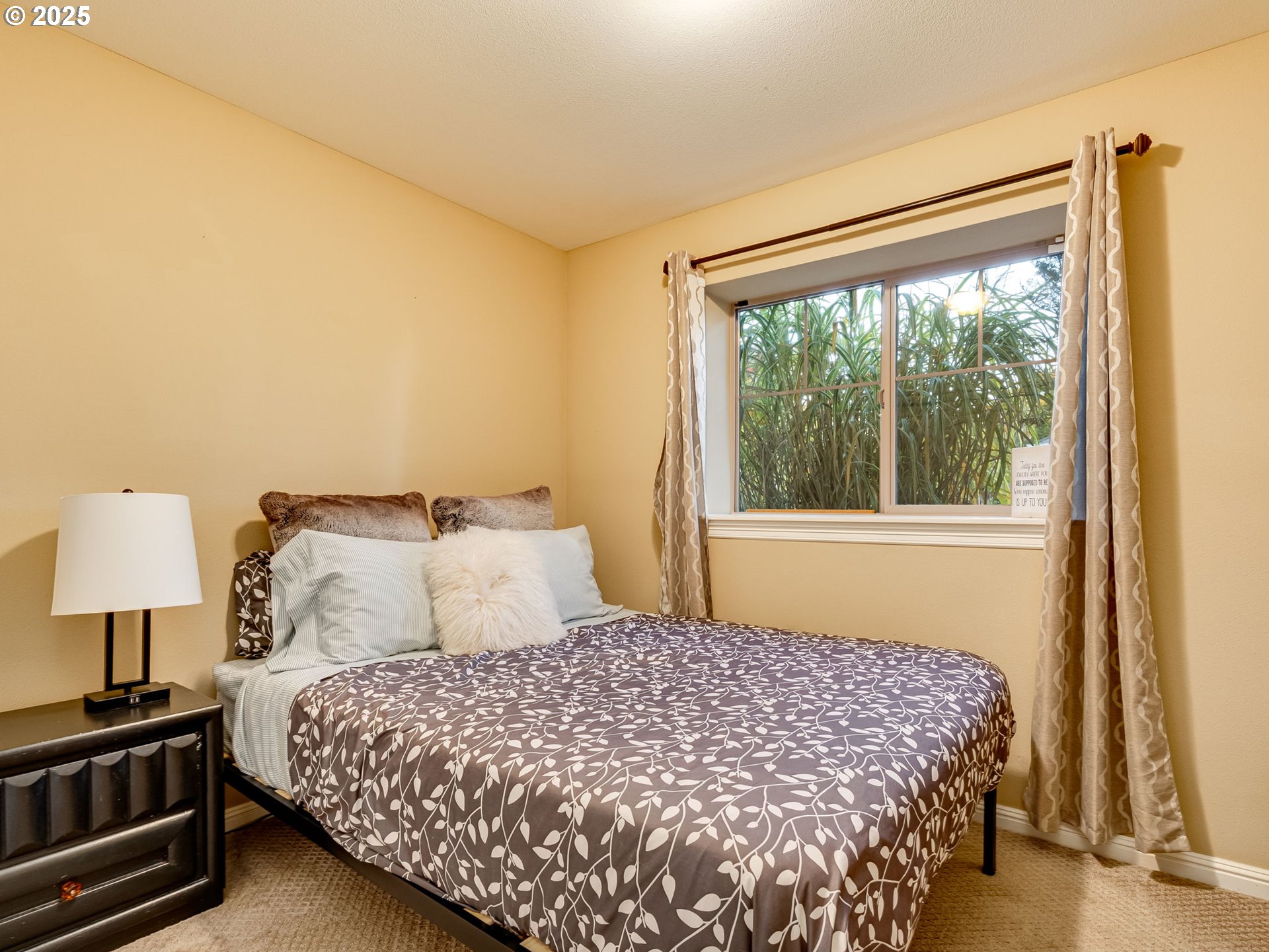8581 Southeast 19th Avenue Portland, OR 97202 - Photo 34 of 39 a bedroom with a bed lamp and a large window
