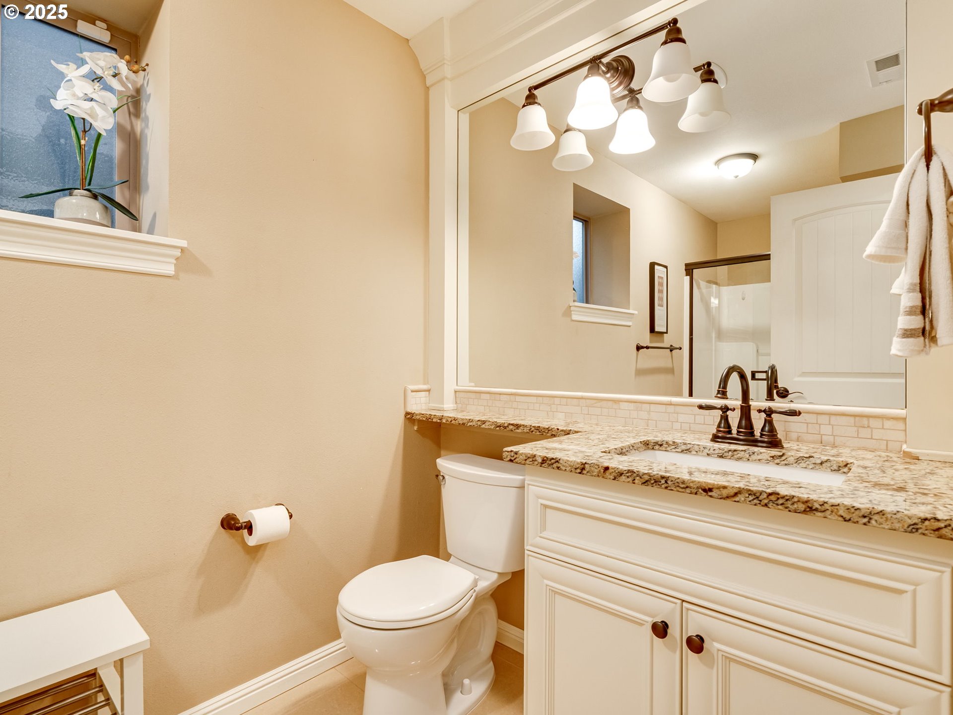 8581 Southeast 19th Avenue Portland, OR 97202 - Photo 35 of 39 a bathroom with a granite countertop sink vanity mirror and toilet