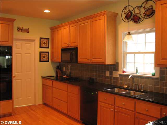 3619 Bailey Farm Road Moseley, VA 23120 - Photo 3 of 12 a kitchen with stainless steel appliances granite countertop a sink stove and refrigerator