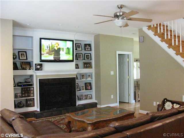 3619 Bailey Farm Road Moseley, VA 23120 - Photo 6 of 12 a living room with furniture a flat screen tv and a fireplace