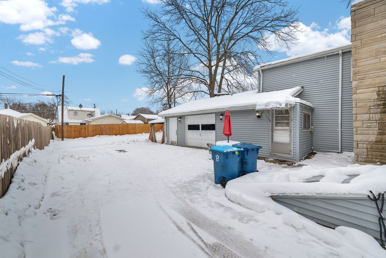 541 Charles Street Aurora, IL 60506 - Photo 30 of 38 a view of a white house with a yard covered in snow