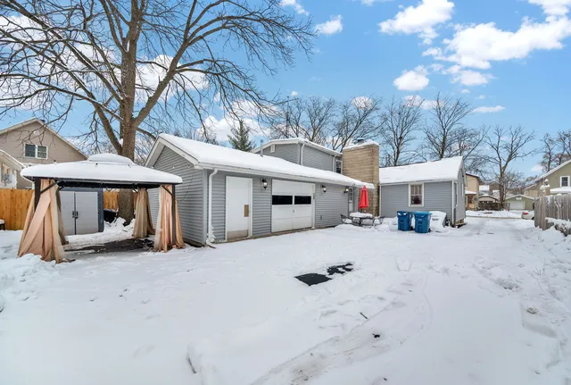 a view of a house with a snow in the yard