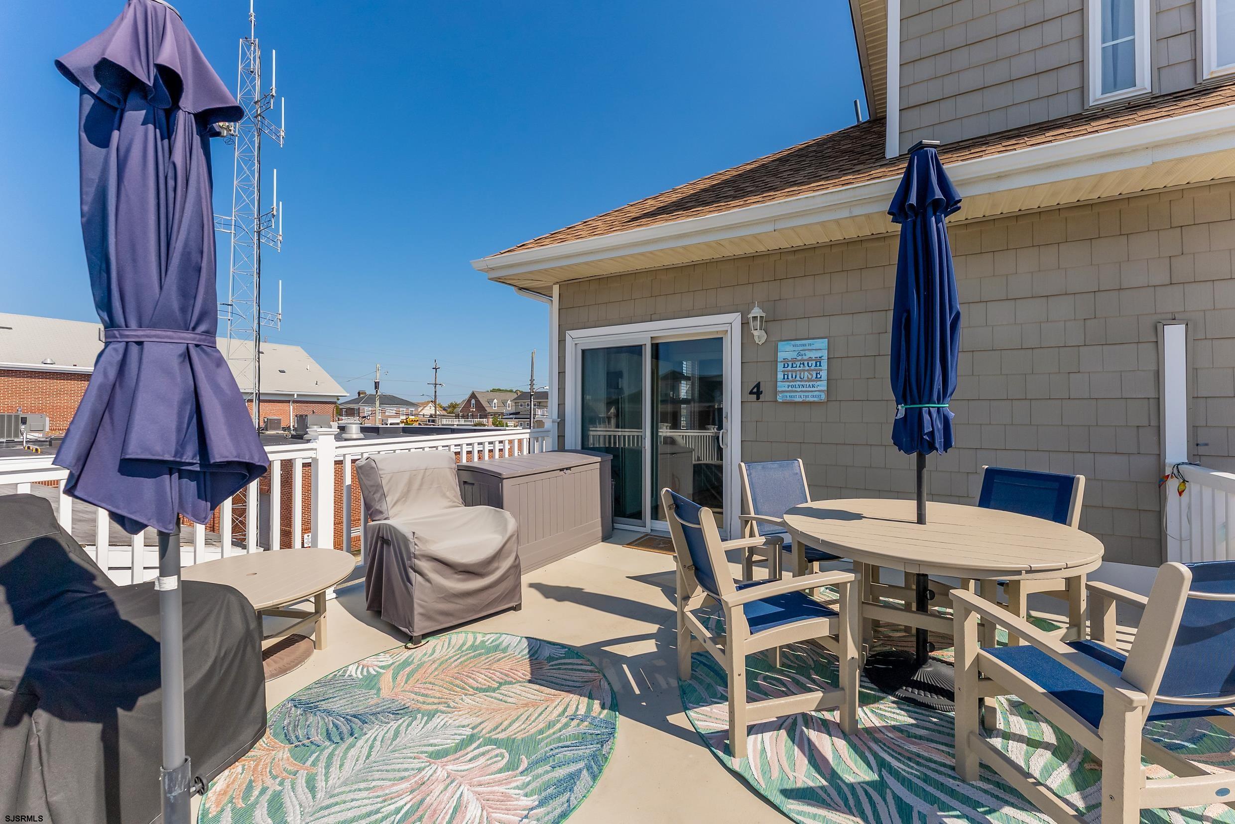 206 East Cardinal Road, Unit 4 Wildwood Crest, NJ 08260 - Photo 12 of 32 a view of a patio with a dining table and chairs