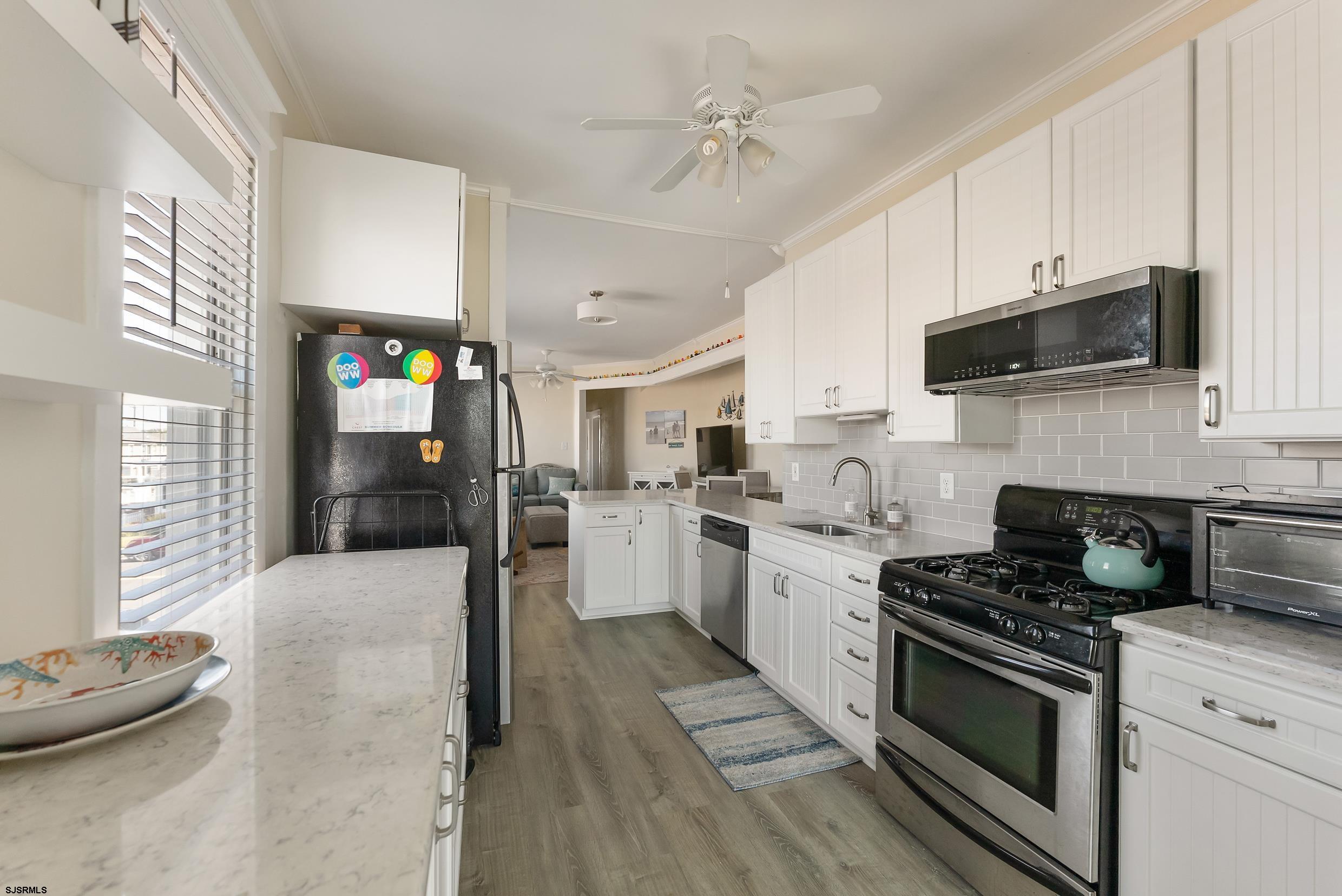 206 East Cardinal Road, Unit 4 Wildwood Crest, NJ 08260 - Photo 14 of 32 a kitchen with a sink stove and refrigerator