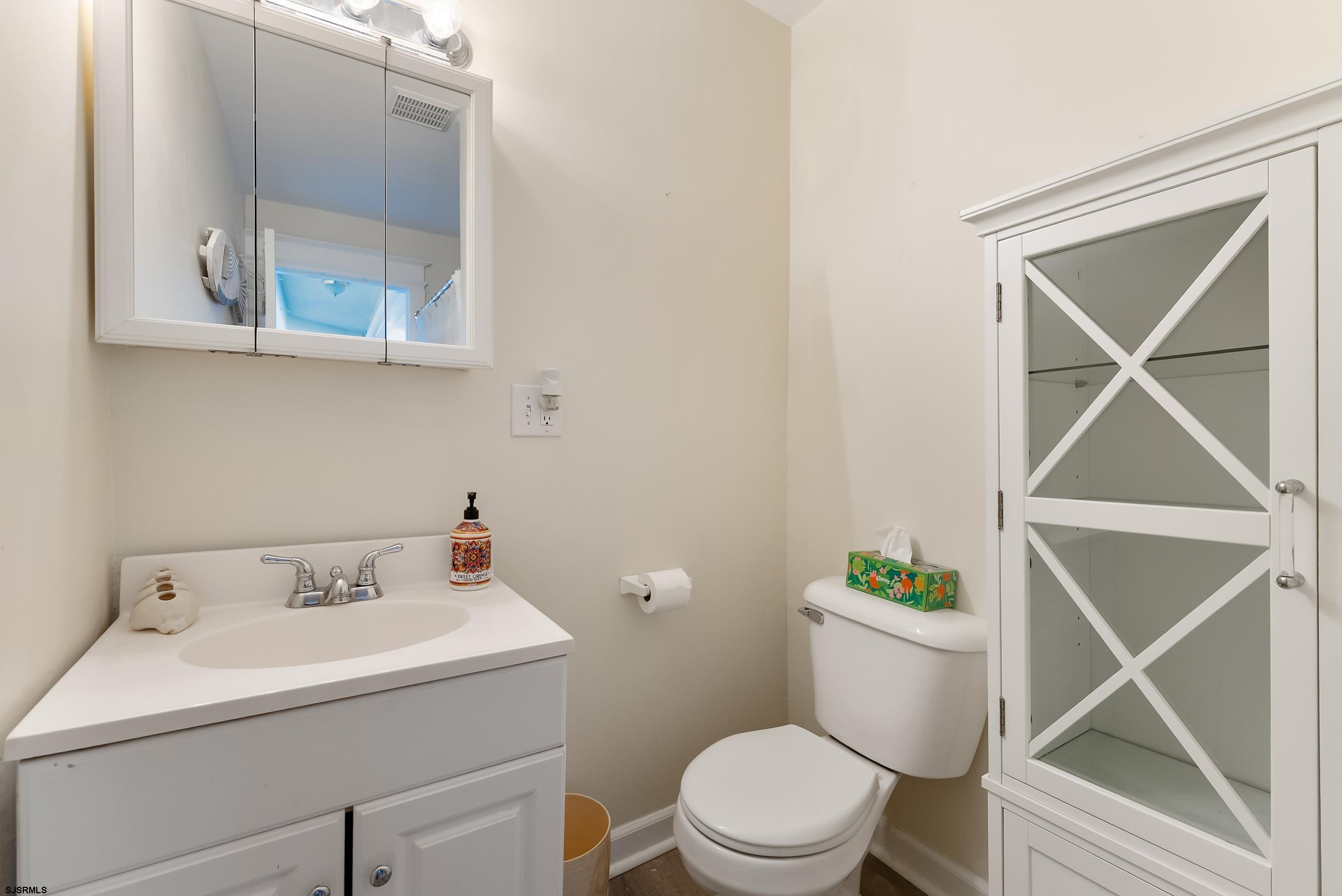 206 East Cardinal Road, Unit 4 Wildwood Crest, NJ 08260 - Photo 18 of 32 a bathroom with a sink mirror and toilet