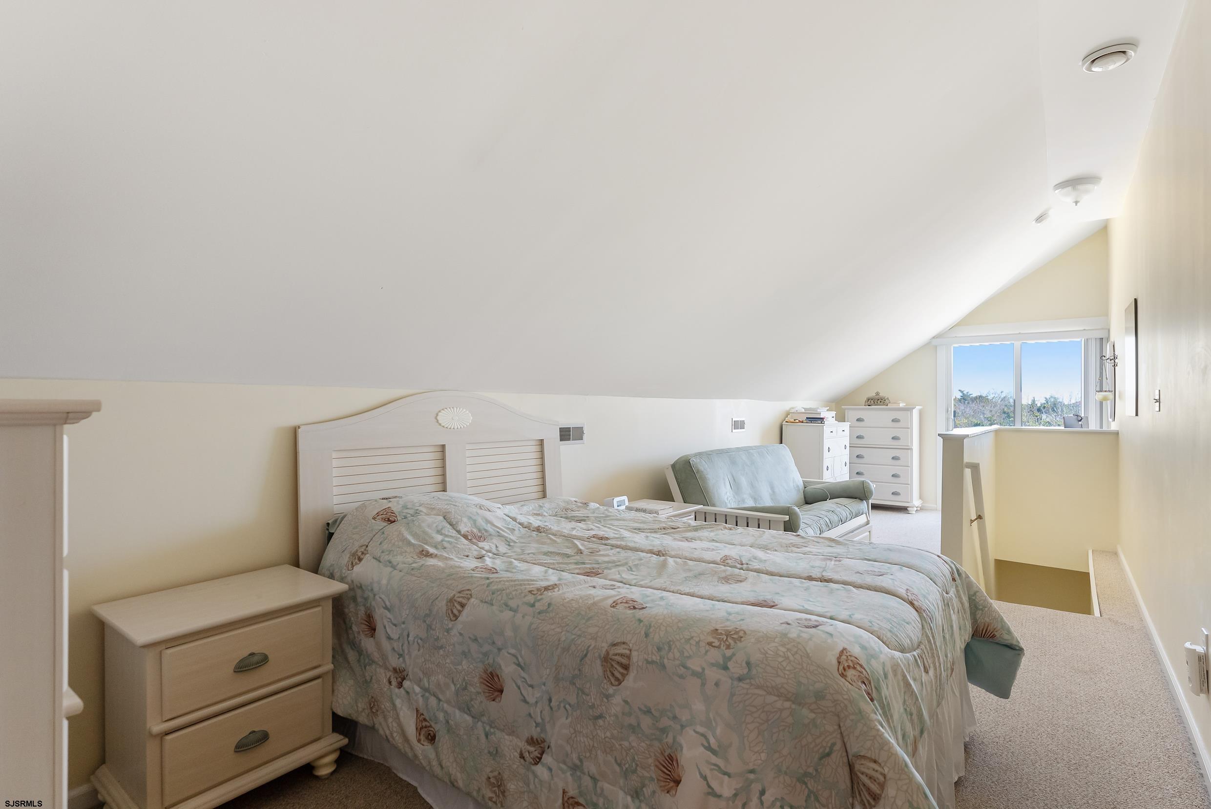 206 East Cardinal Road, Unit 4 Wildwood Crest, NJ 08260 - Photo 26 of 32 a large bed sitting in a bedroom next to a larger window