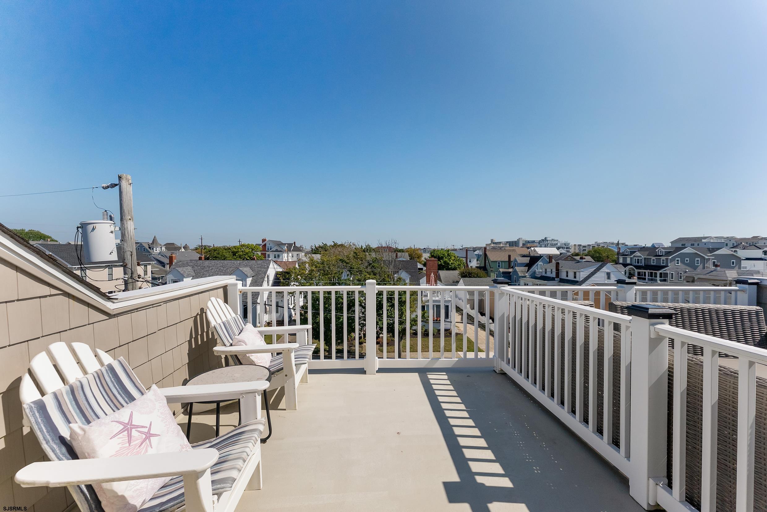 206 East Cardinal Road, Unit 4 Wildwood Crest, NJ 08260 - Photo 27 of 32 a view of a balcony with chair and iron fence