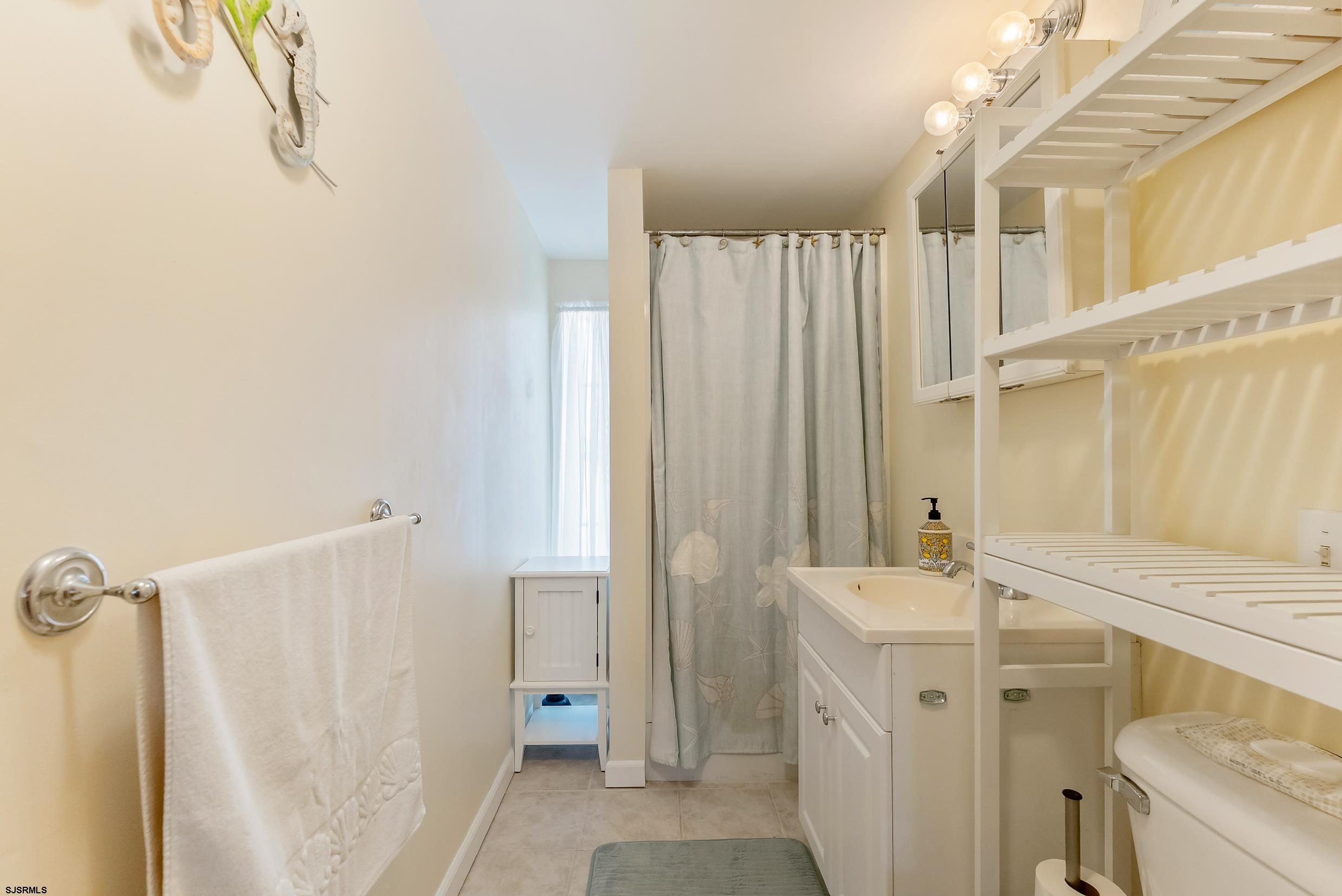 206 East Cardinal Road, Unit 4 Wildwood Crest, NJ 08260 - Photo 32 of 32 a bathroom with a sink a toilet and shower