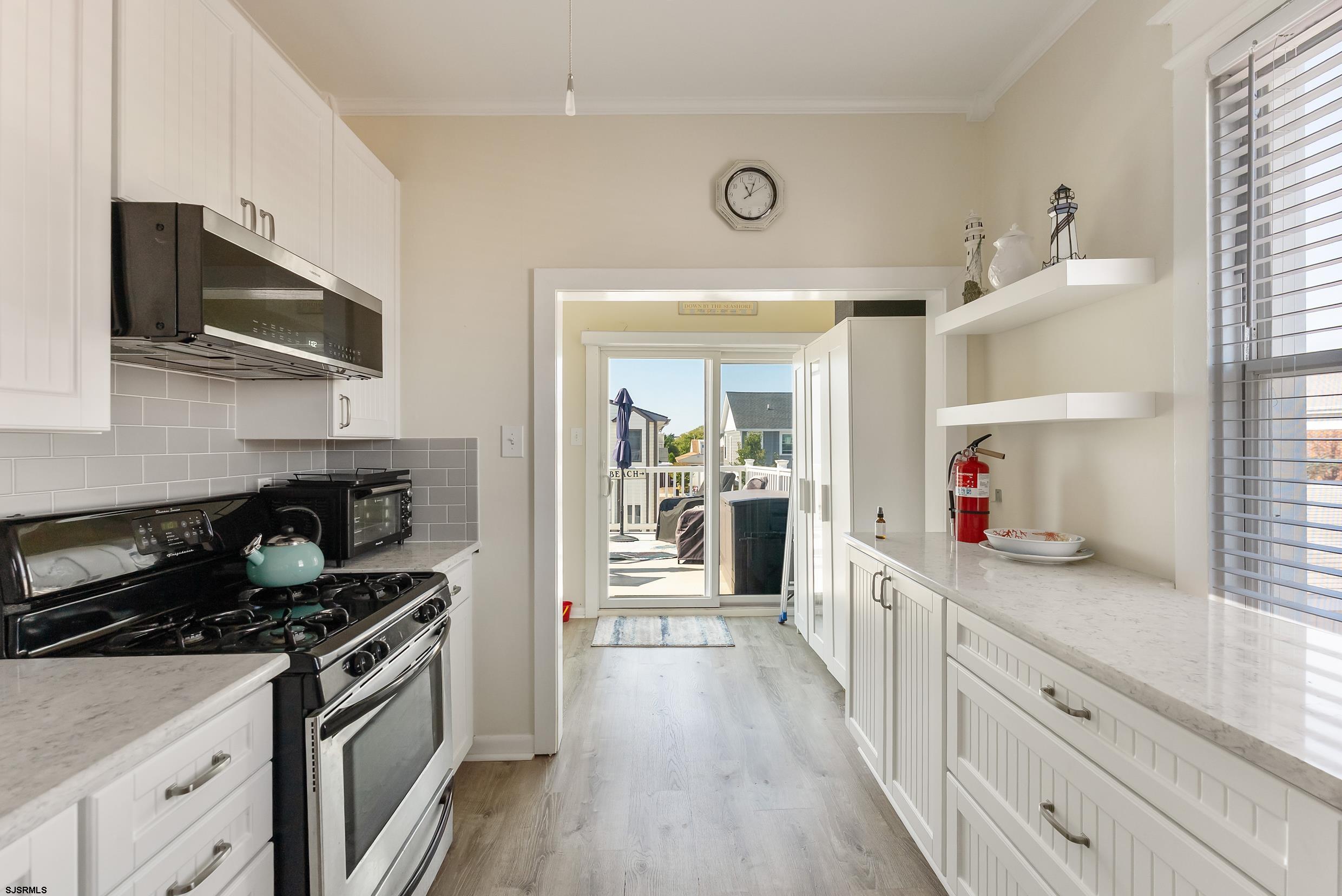 206 East Cardinal Road, Unit 4 Wildwood Crest, NJ 08260 - Photo 9 of 32 a kitchen with stainless steel appliances granite countertop a stove and a microwave