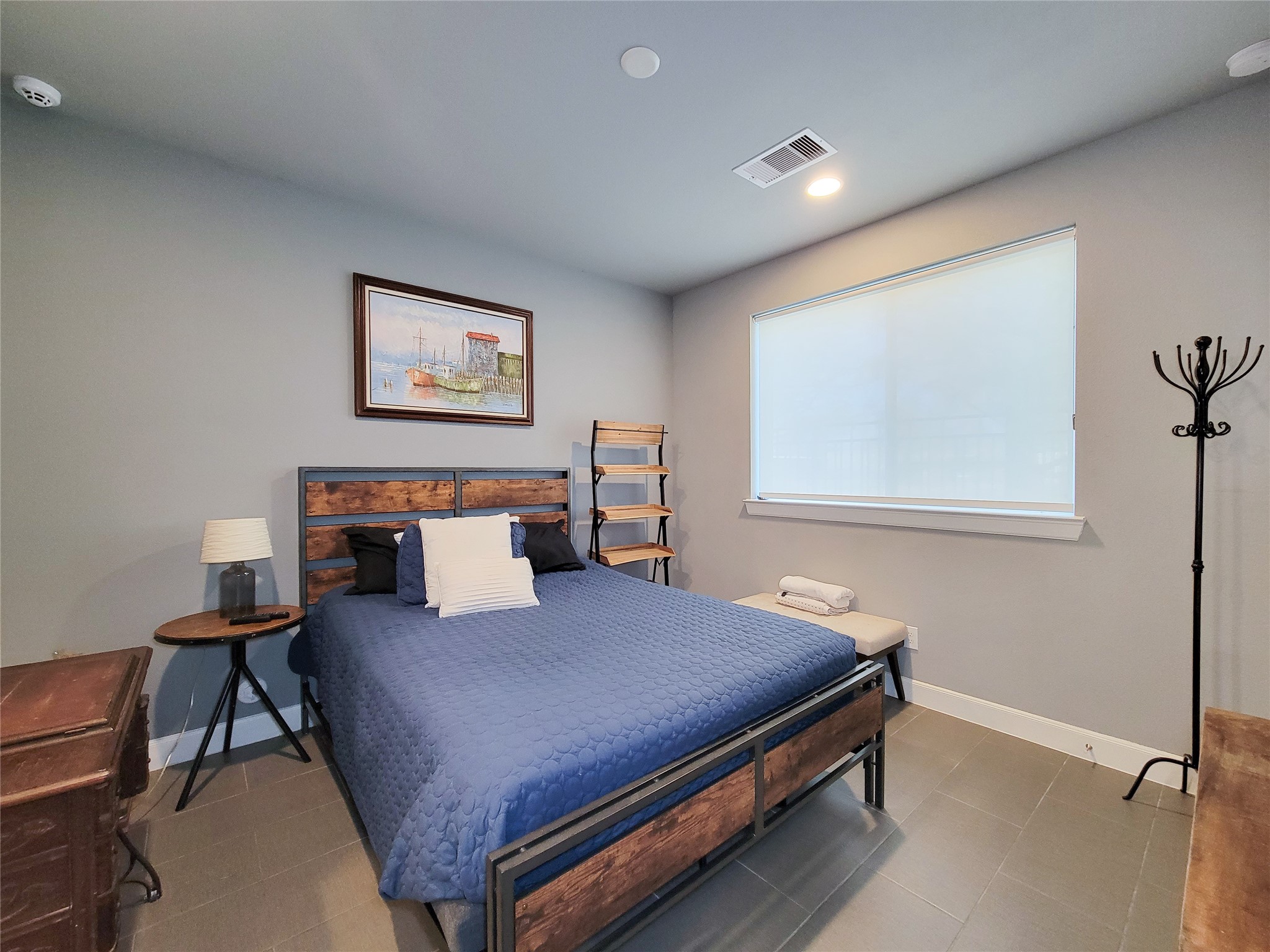 1705 Eado Point Lane Houston, TX 77003 - Photo 8 of 50 1st Floor Bedroom/Guest Suite has a large window allowing natural light with recessed lighting and tiled flooring.