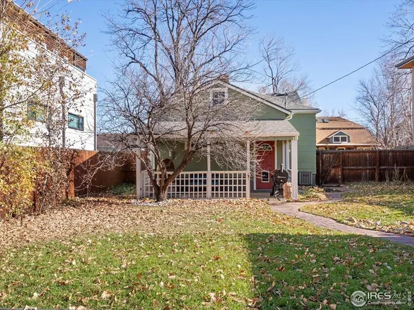 a view of a house with a yard covered in snow