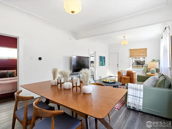 a living room with furniture wooden floor and a flat screen tv
