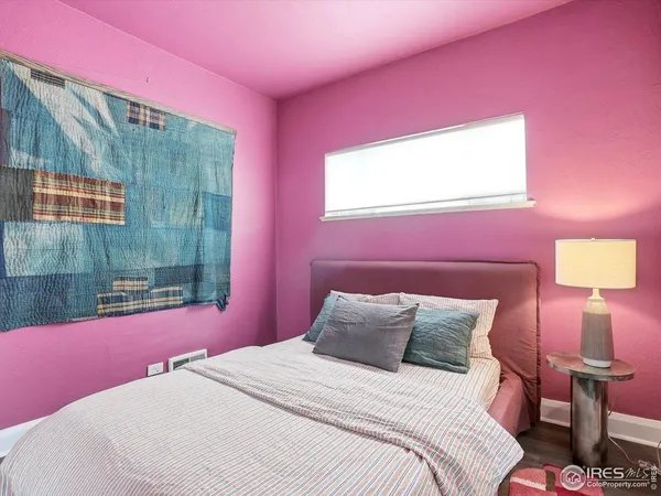 a bedroom with a bed and a chair